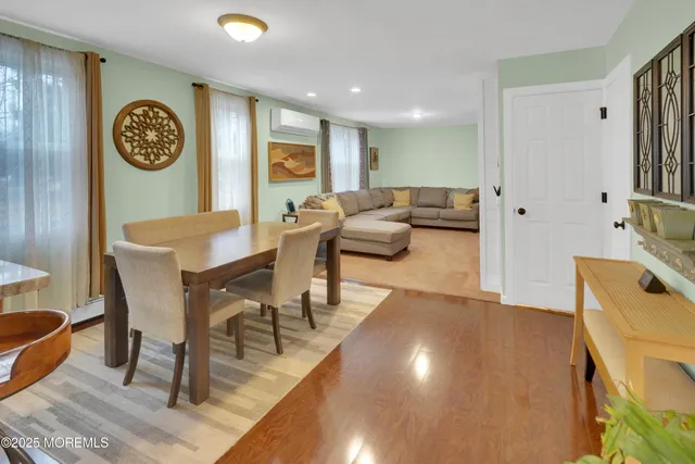 a living room with couches and a wall painting