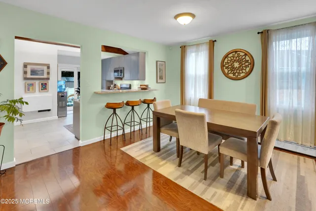 a view of a dining room with furniture and a large window