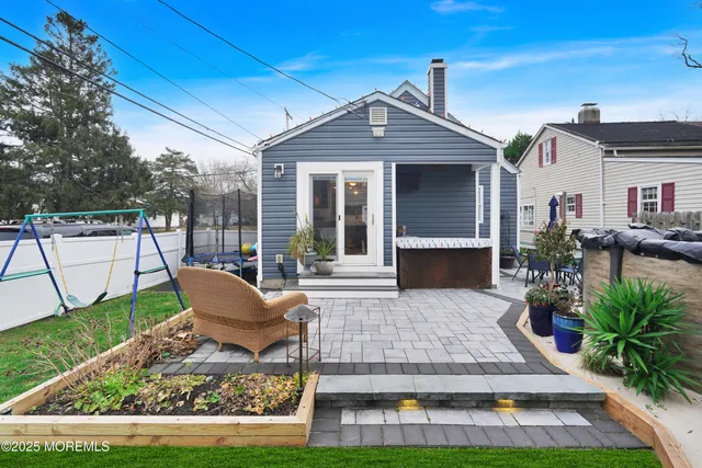 a view of a house with backyard porch and sitting area
