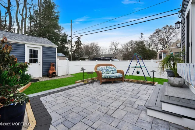 a view of a chair and table in backyard of the house