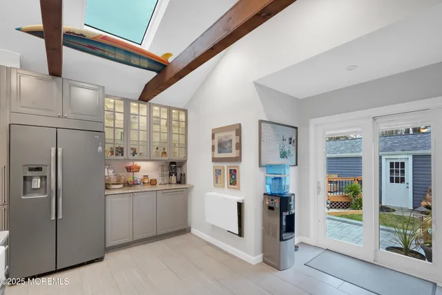 a kitchen with stainless steel appliances granite countertop a refrigerator and a sink