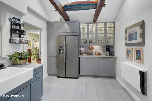 a kitchen with refrigerator and cabinets