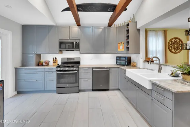 a kitchen with a sink stove and refrigerator