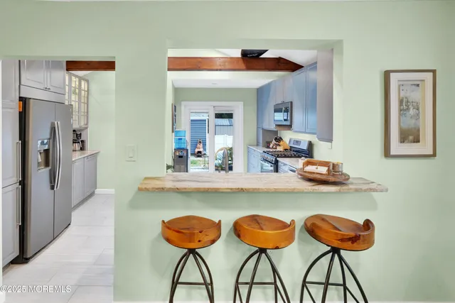 a view of dining table chairs and chandelier