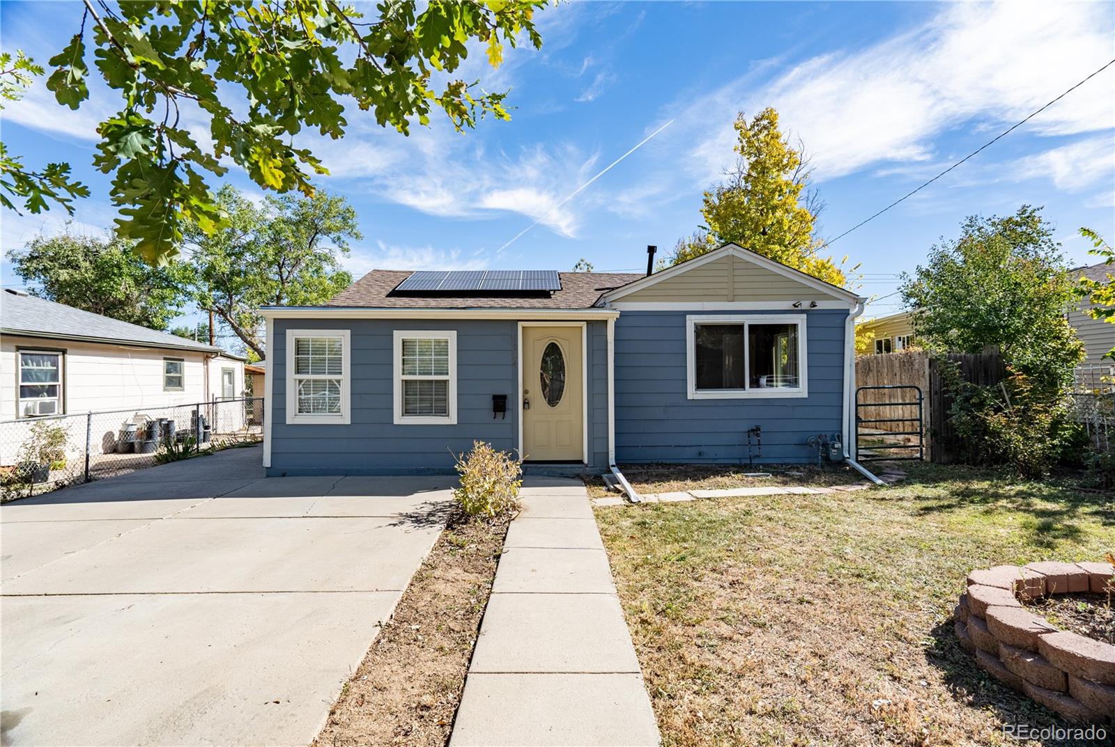 1124 Newark Street Aurora, CO 80010 - Photo 1 of 32 a front view of a house with a yard