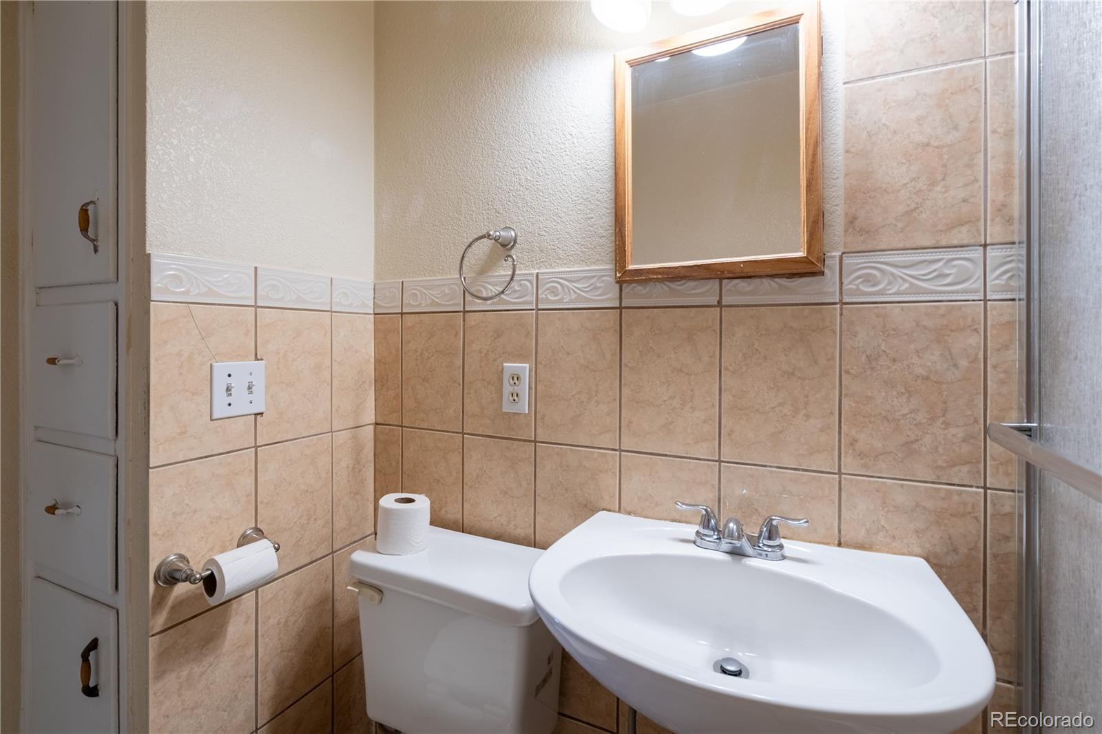 1124 Newark Street Aurora, CO 80010 - Photo 12 of 32 a bathroom with a sink and mirror