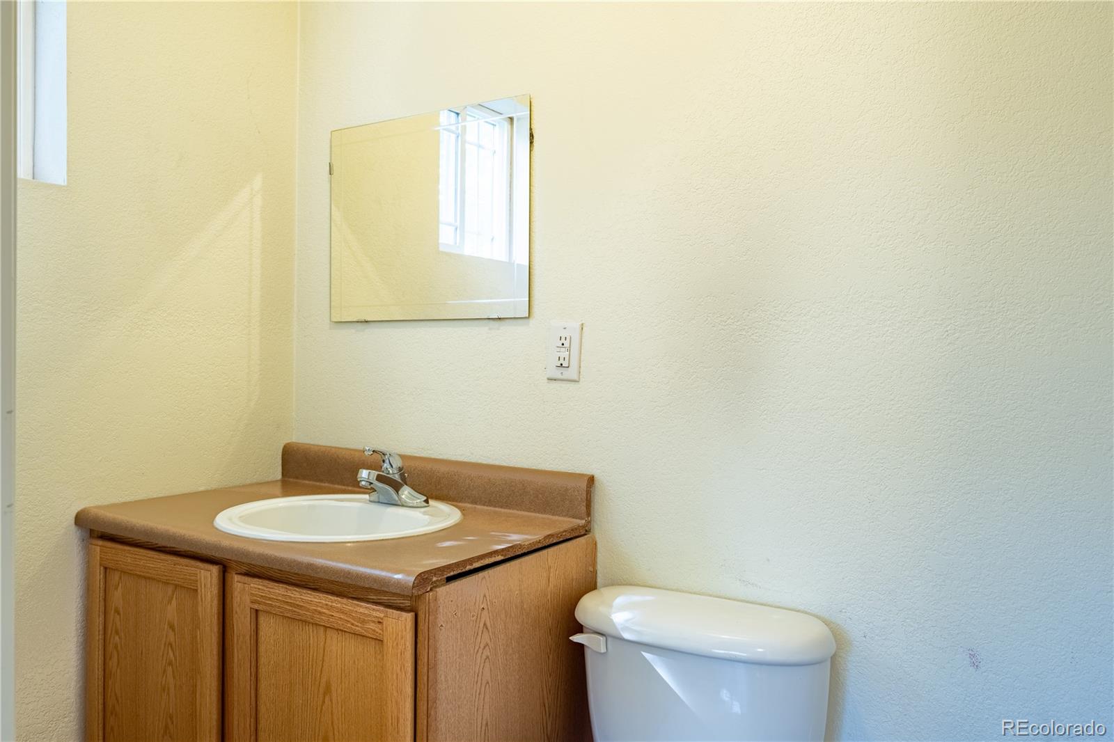 1124 Newark Street Aurora, CO 80010 - Photo 16 of 32 a bathroom with a sink and a toilet