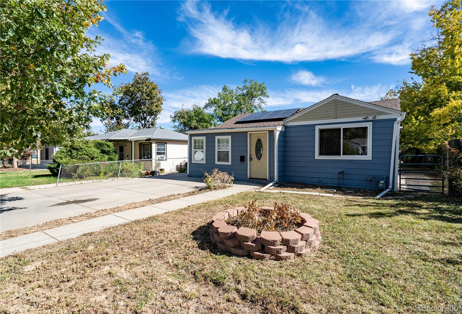1124 Newark Street Aurora, CO 80010 - Photo 2 of 32 a front view of a house with a yard
