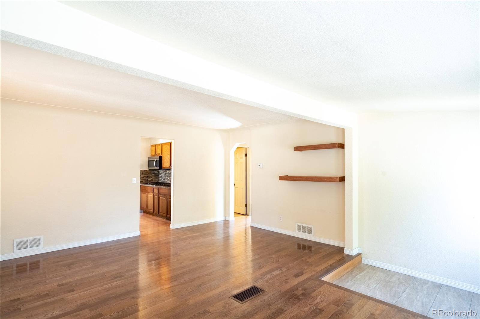 1124 Newark Street Aurora, CO 80010 - Photo 5 of 32 a view of a livingroom with wooden floor