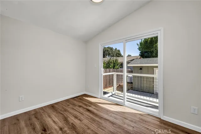 a view of a room with wooden floor and a window