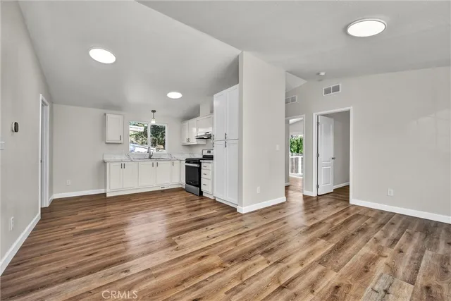 a view of a kitchen with wooden floor