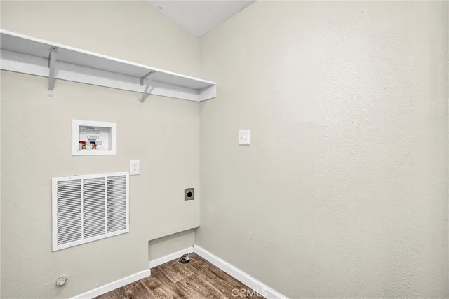 a view of small space with wooden floor and windows