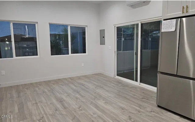 an empty room with wooden floor and a window