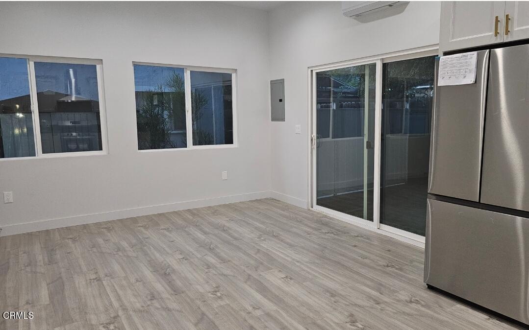 214 Valle Vista Avenue, Unit 2 Monrovia, CA 91016 - Photo 4 of 11 an empty room with wooden floor and a window