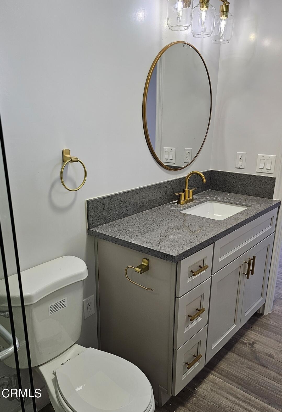 214 Valle Vista Avenue, Unit 2 Monrovia, CA 91016 - Photo 5 of 11 a bathroom with a granite countertop toilet sink and mirror