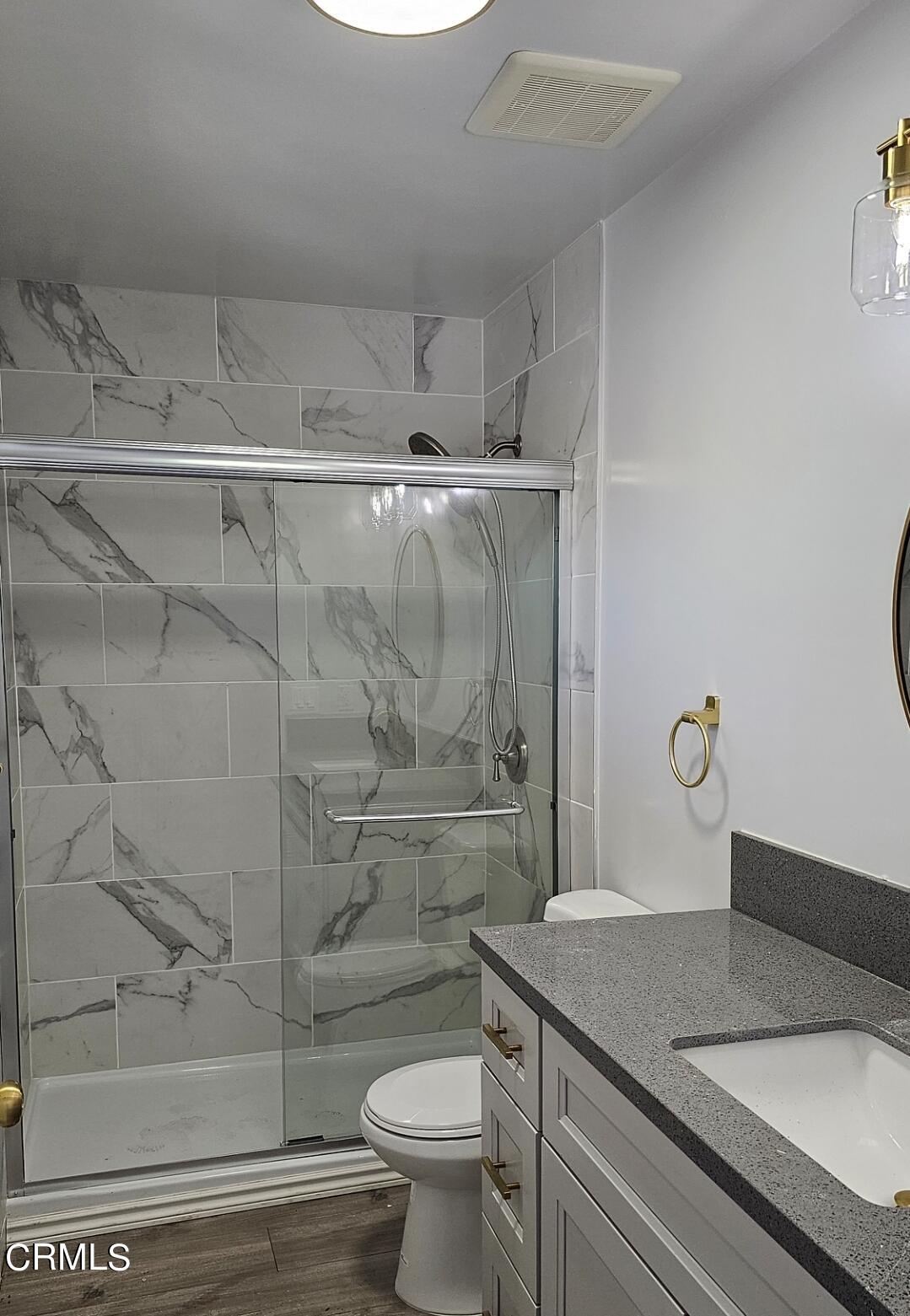 214 Valle Vista Avenue, Unit 2 Monrovia, CA 91016 - Photo 6 of 11 a bathroom with a granite countertop sink a toilet and shower