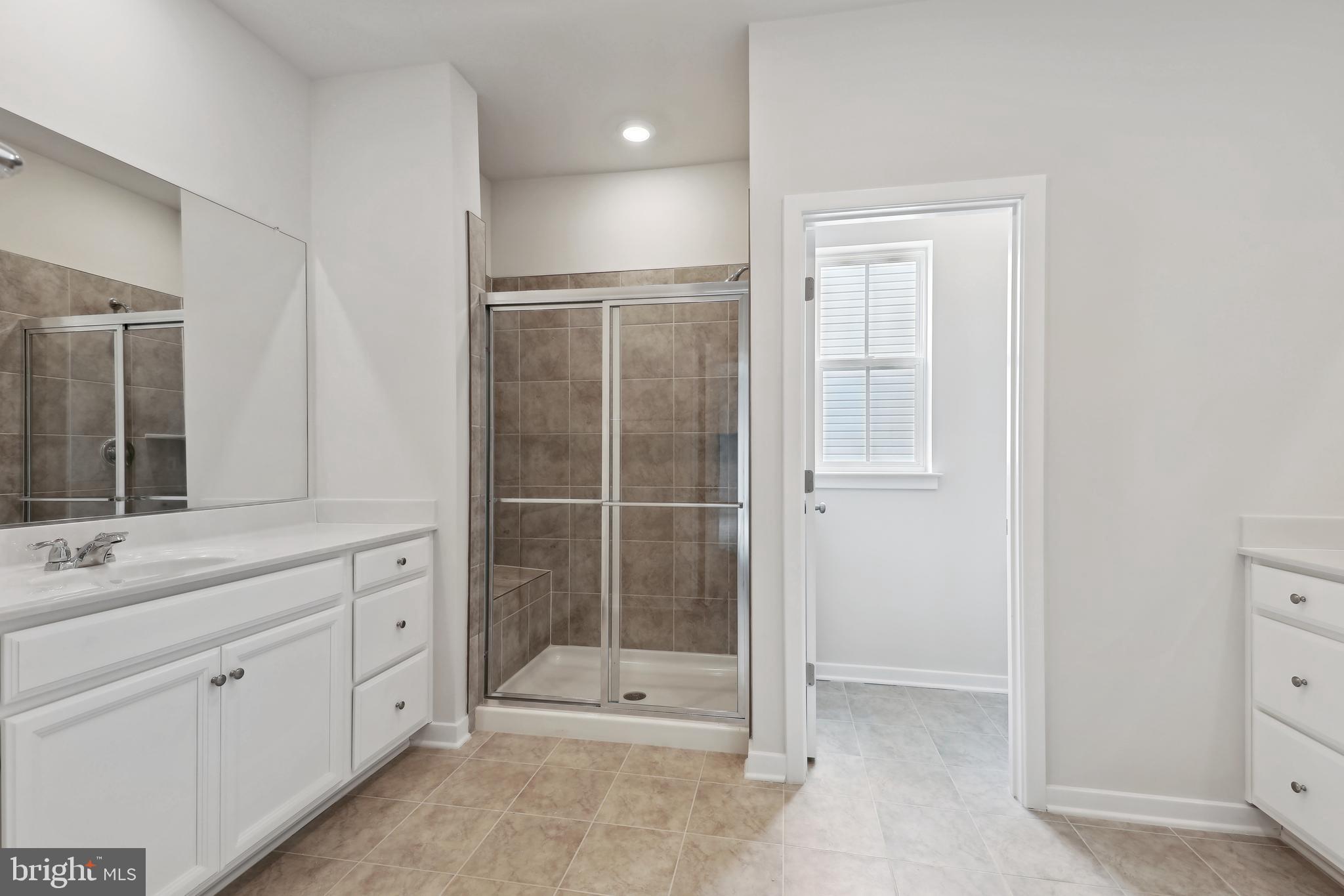 430 Silver Birch Drive, Unit ASHTON 241 Ranson, WV 25438 - Photo 21 of 23 a bathroom with a shower sink and mirror