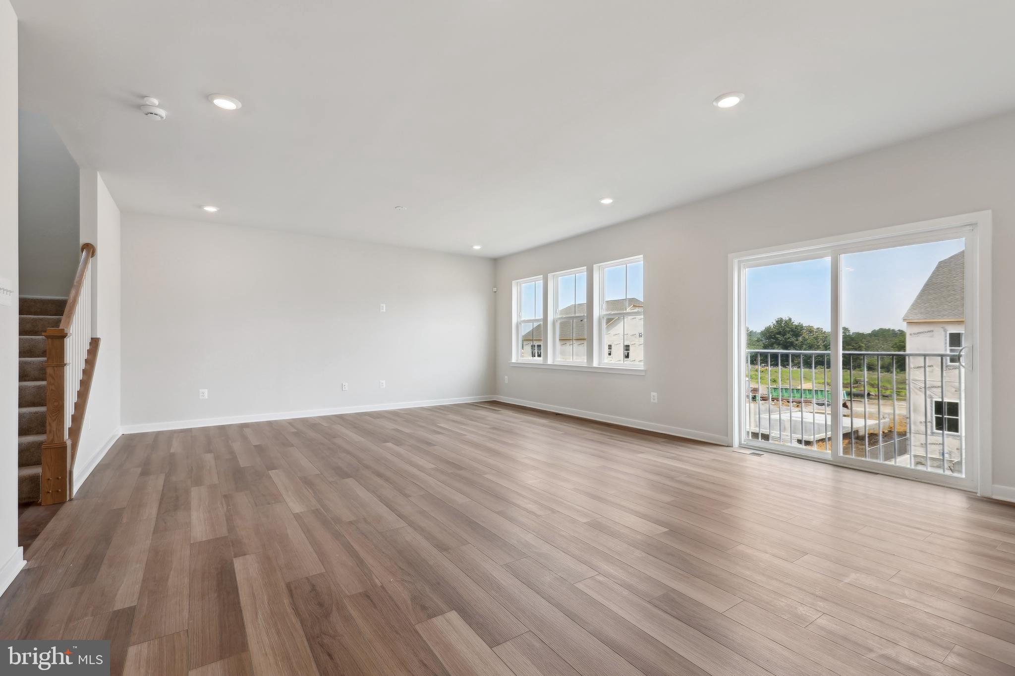 430 Silver Birch Drive, Unit ASHTON 241 Ranson, WV 25438 - Photo 4 of 23 an empty room with wooden floor and windows