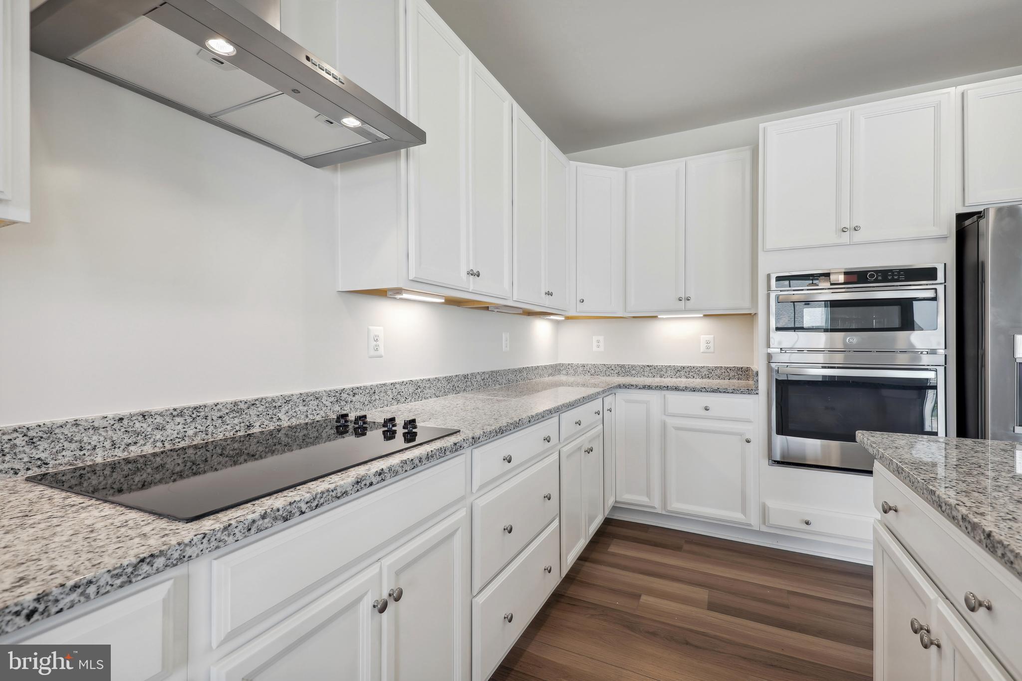 430 Silver Birch Drive, Unit ASHTON 241 Ranson, WV 25438 - Photo 7 of 23 a kitchen with granite countertop white cabinets and white appliances