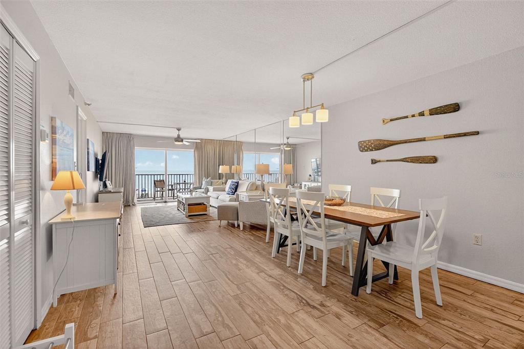 14300 Gulf Boulevard, Unit 104 Madeira Beach, FL 33708 - Photo 12 of 42 a view of a dining room with furniture window and wooden floor