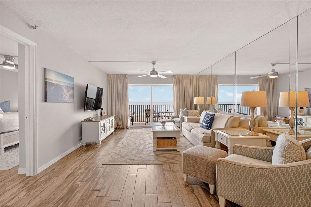 14300 Gulf Boulevard, Unit 104 Madeira Beach, FL 33708 - Photo 14 of 42 a living room with furniture kitchen view and a large window