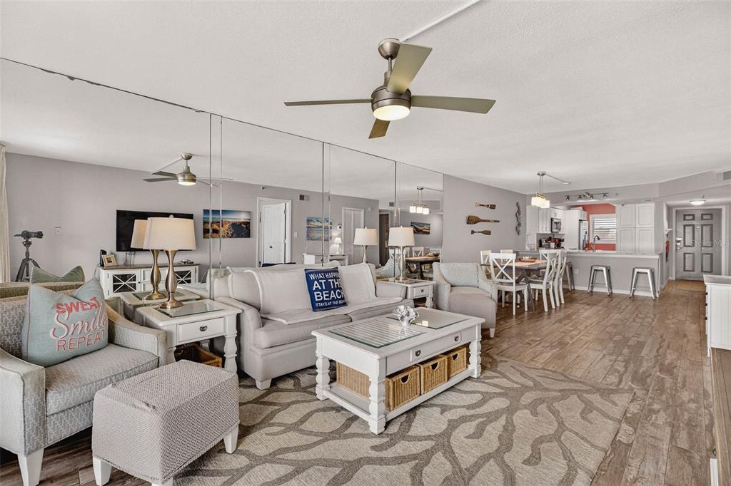 14300 Gulf Boulevard, Unit 104 Madeira Beach, FL 33708 - Photo 17 of 42 a living room with lots of furniture and a chandelier