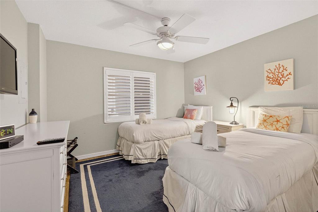 14300 Gulf Boulevard, Unit 104 Madeira Beach, FL 33708 - Photo 18 of 42 a bedroom with a bed and a desk