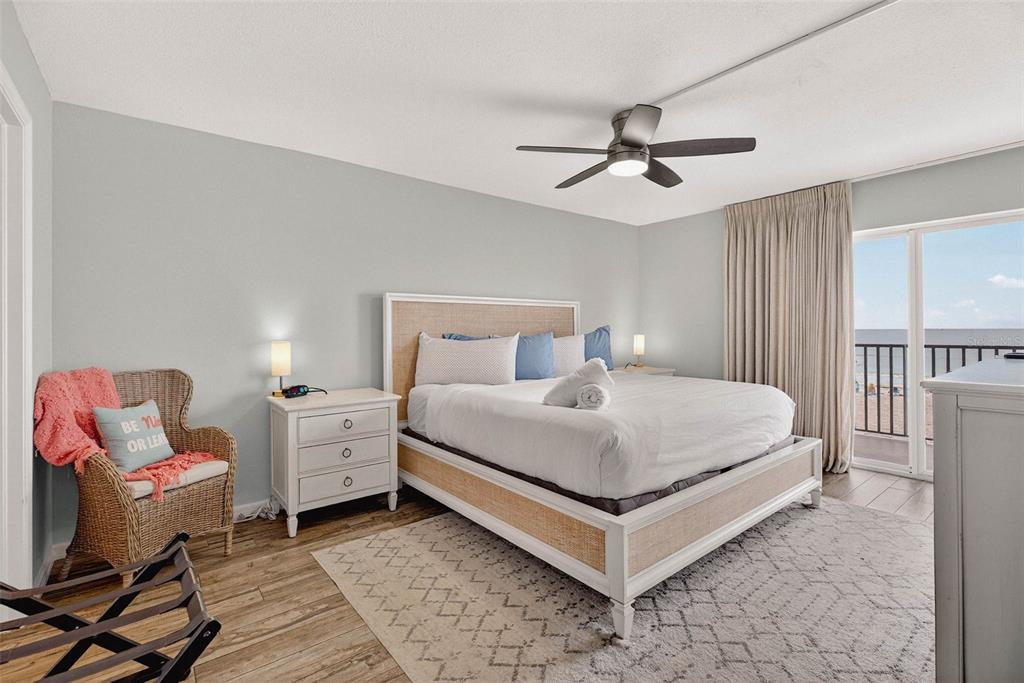 14300 Gulf Boulevard, Unit 104 Madeira Beach, FL 33708 - Photo 21 of 42 a bedroom with a bed and a chandelier