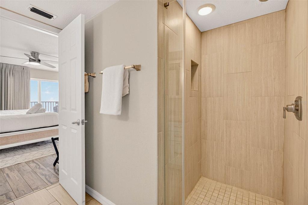 14300 Gulf Boulevard, Unit 104 Madeira Beach, FL 33708 - Photo 25 of 42 a bathroom with a shower and a sink