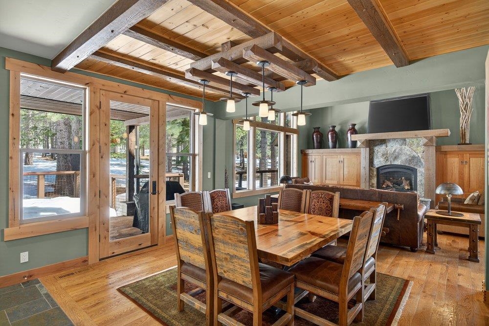 15043 Wolfgang Road Truckee, CA 96161 - Photo 11 of 28 a dining room with furniture a fireplace and wooden floor