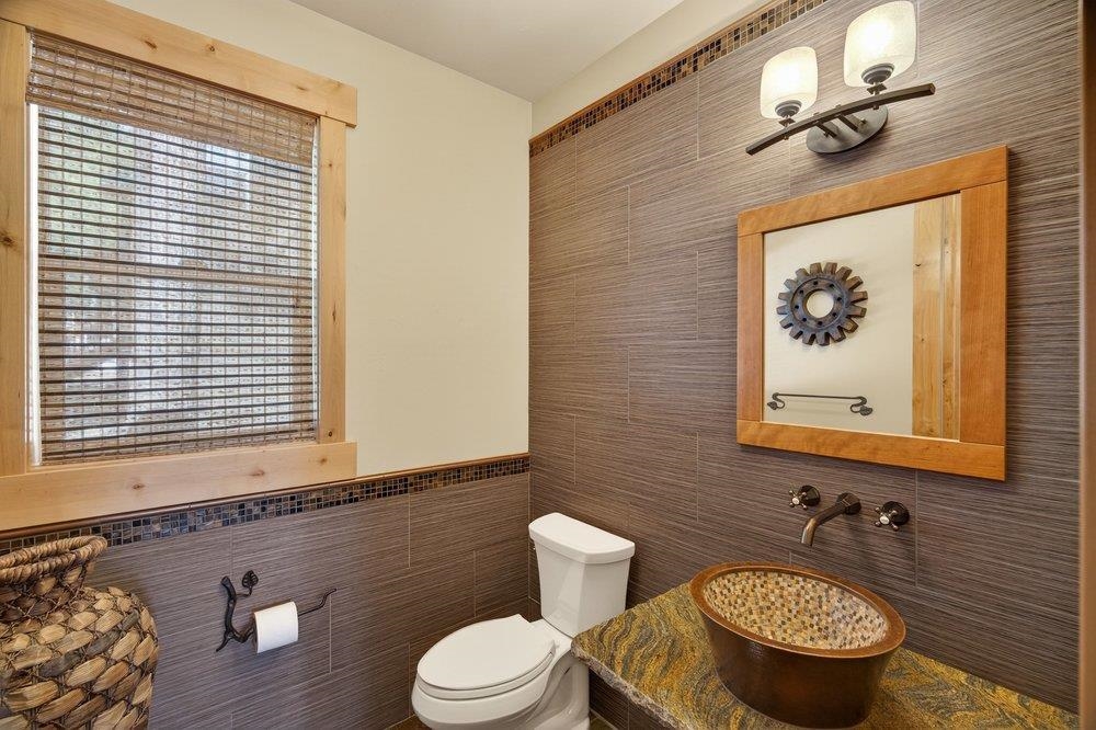 15043 Wolfgang Road Truckee, CA 96161 - Photo 12 of 28 a bathroom with a toilet a sink and mirror