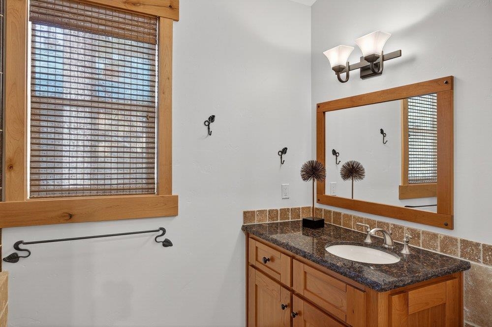 15043 Wolfgang Road Truckee, CA 96161 - Photo 14 of 28 a bathroom with a granite countertop sink and a mirror