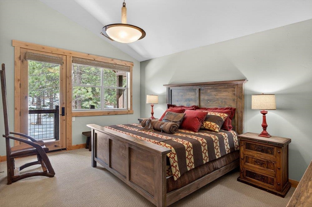 15043 Wolfgang Road Truckee, CA 96161 - Photo 23 of 28 a bed room with a bed and a chandelier