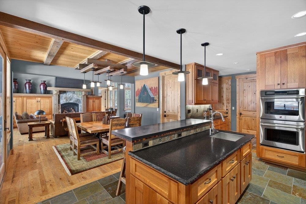 15043 Wolfgang Road Truckee, CA 96161 - Photo 10 of 28 a kitchen with stainless steel appliances granite countertop a stove a sink and a refrigerator
