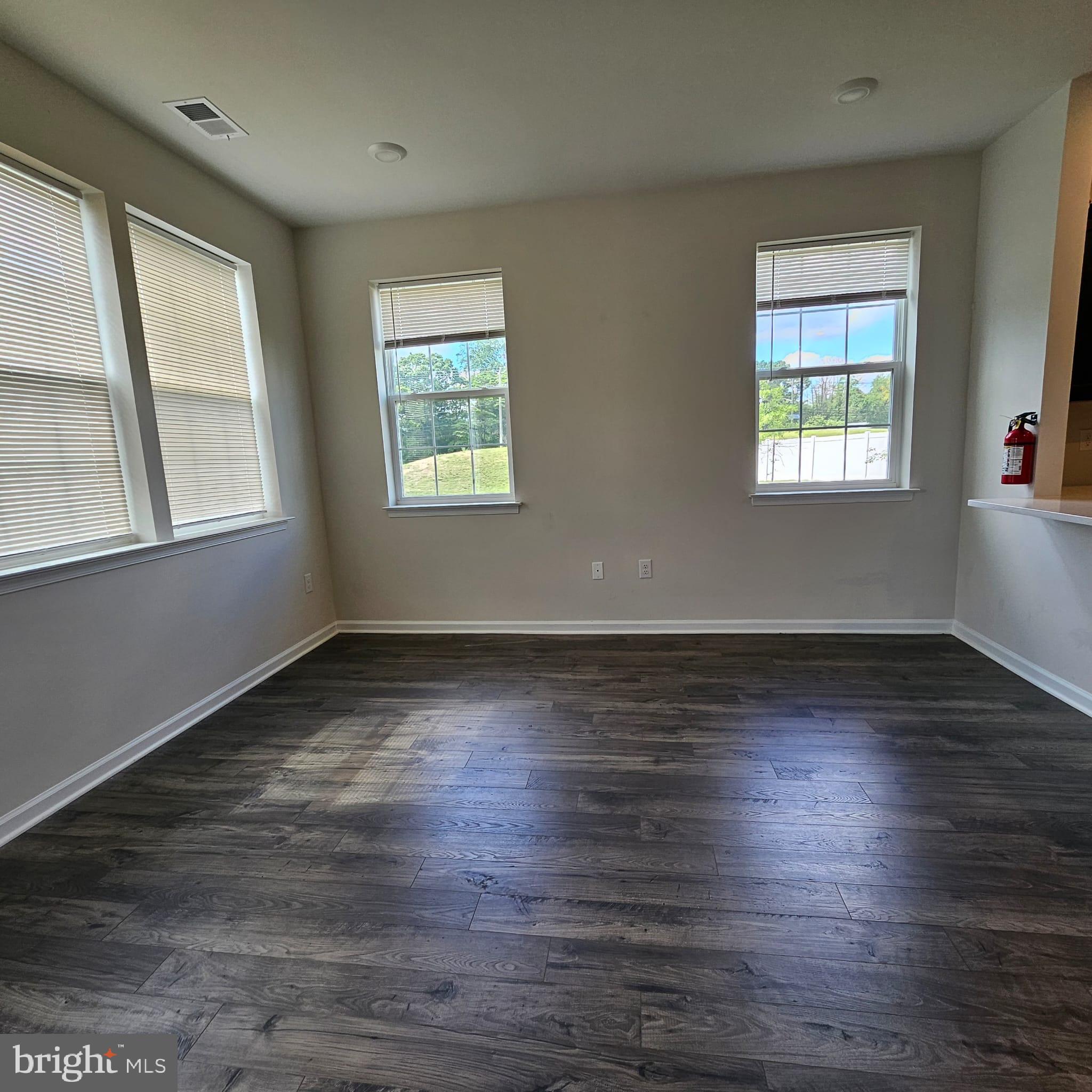 38 Peregrine Way Burlington, NJ 08016 - Photo 12 of 34 an empty room with wooden floor and windows
