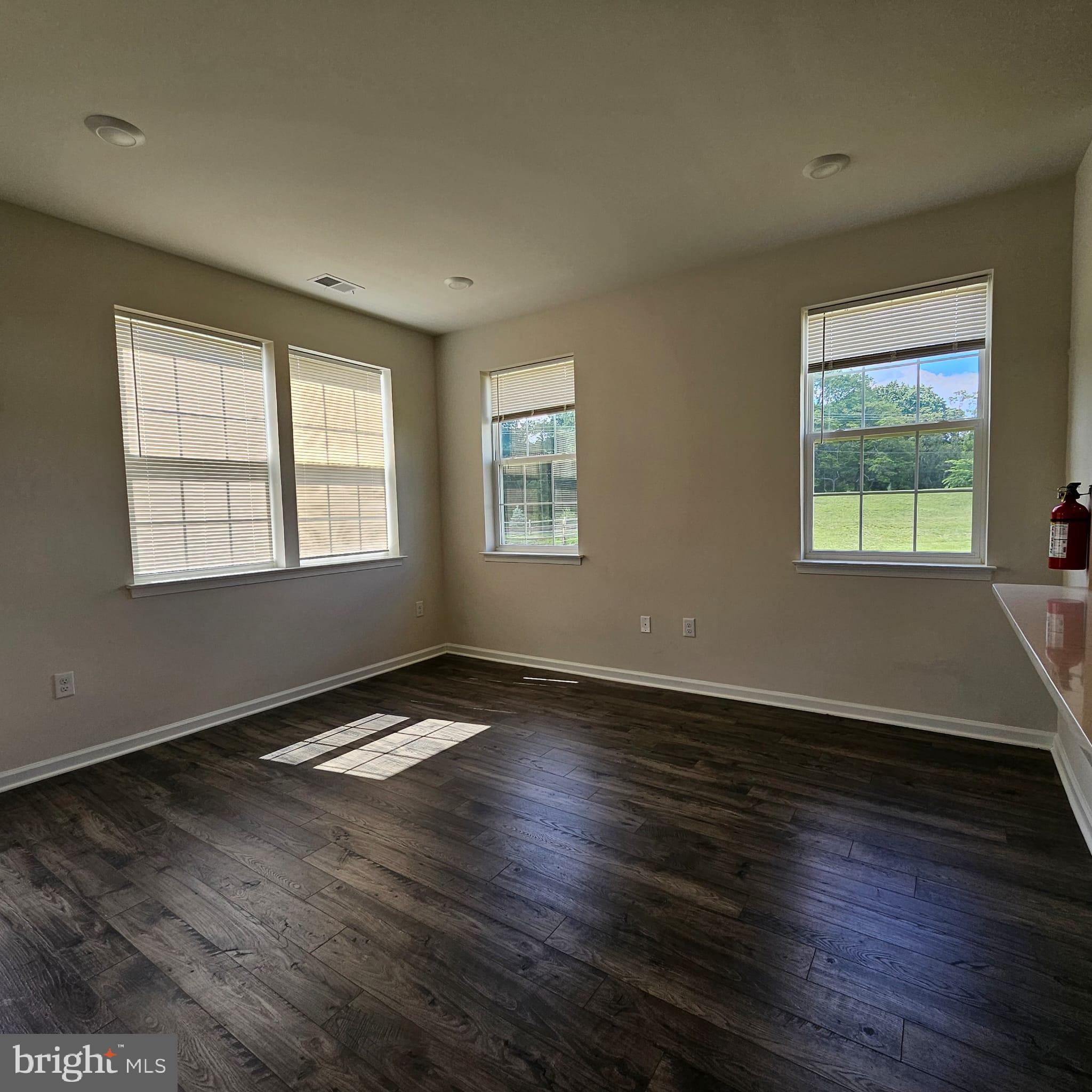 38 Peregrine Way Burlington, NJ 08016 - Photo 14 of 34 a view of an empty room with wooden floor and a window