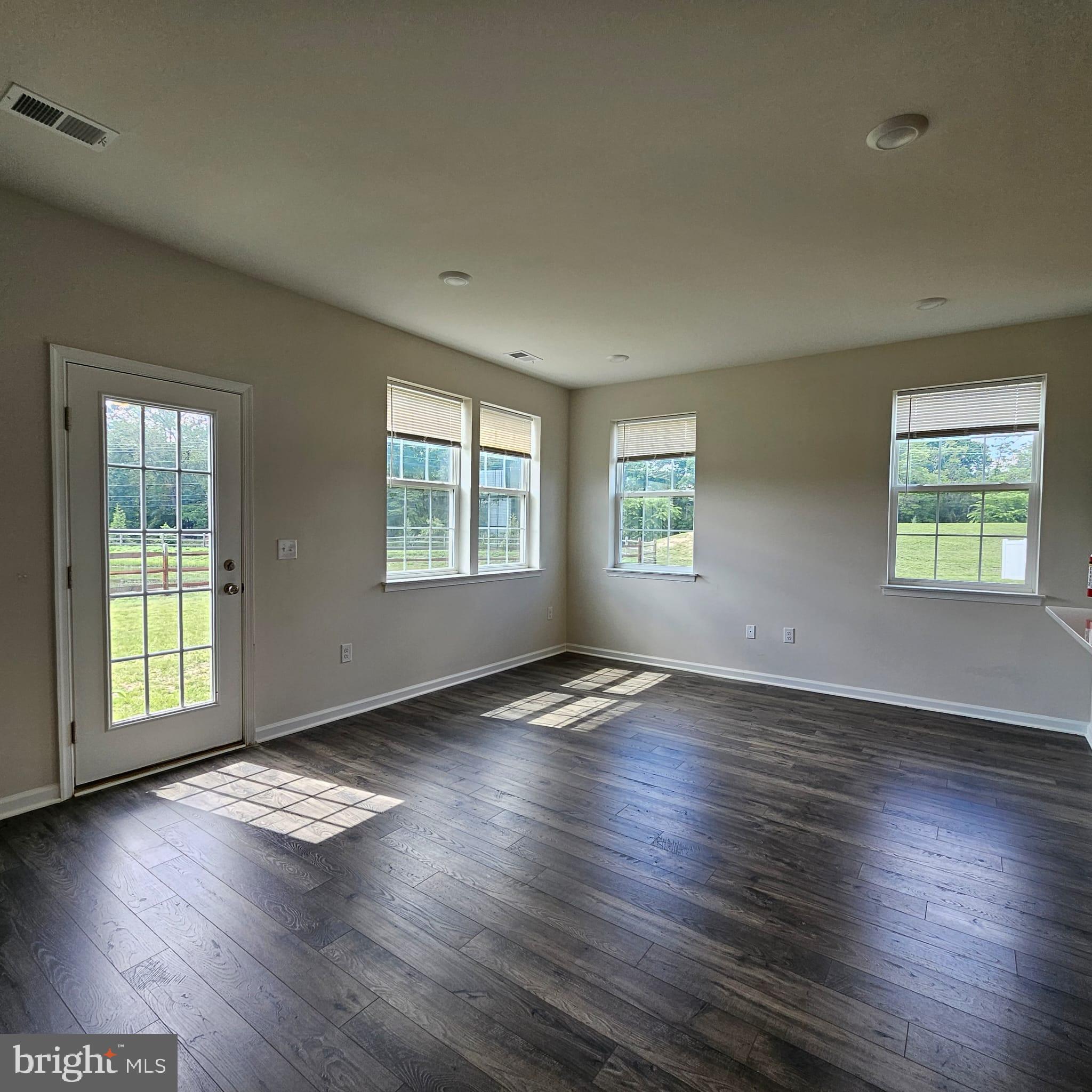 38 Peregrine Way Burlington, NJ 08016 - Photo 15 of 34 an empty room with wooden floor and windows