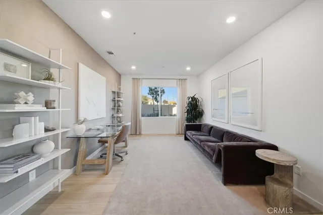 a living room with furniture a rug and white walls