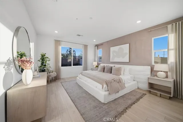 a spacious bedroom with a large bed and a couch