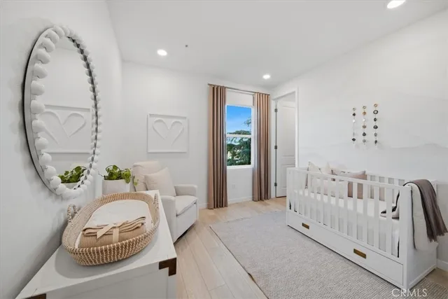 a spacious bedroom with a bed and a chair