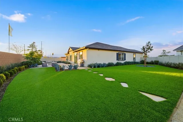 a view of house with backyard