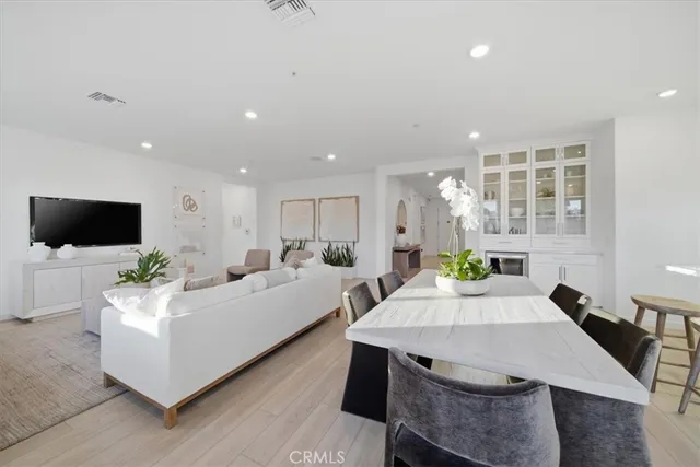 a living room with furniture a flat screen tv and a large window