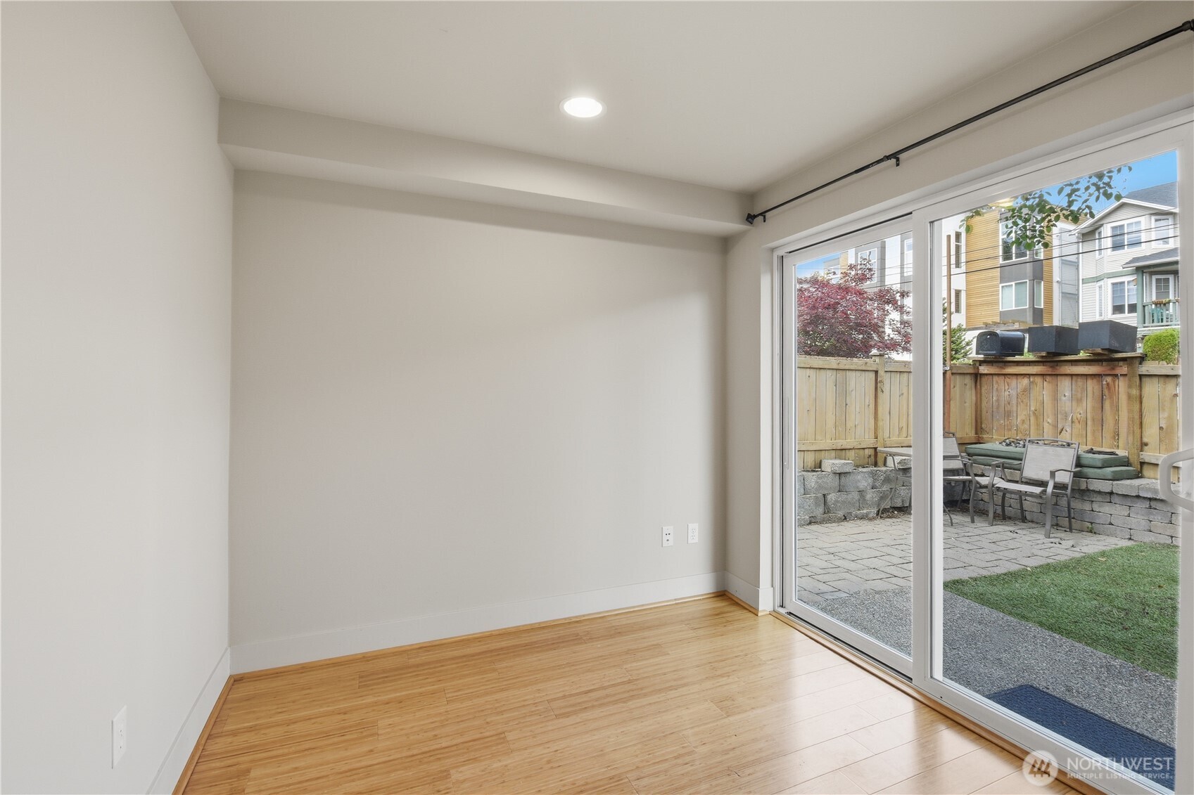 723 North 95th Street, Unit A Seattle, WA 98103 - Photo 8 of 20 a view of empty room with wooden floor and floor to ceiling window