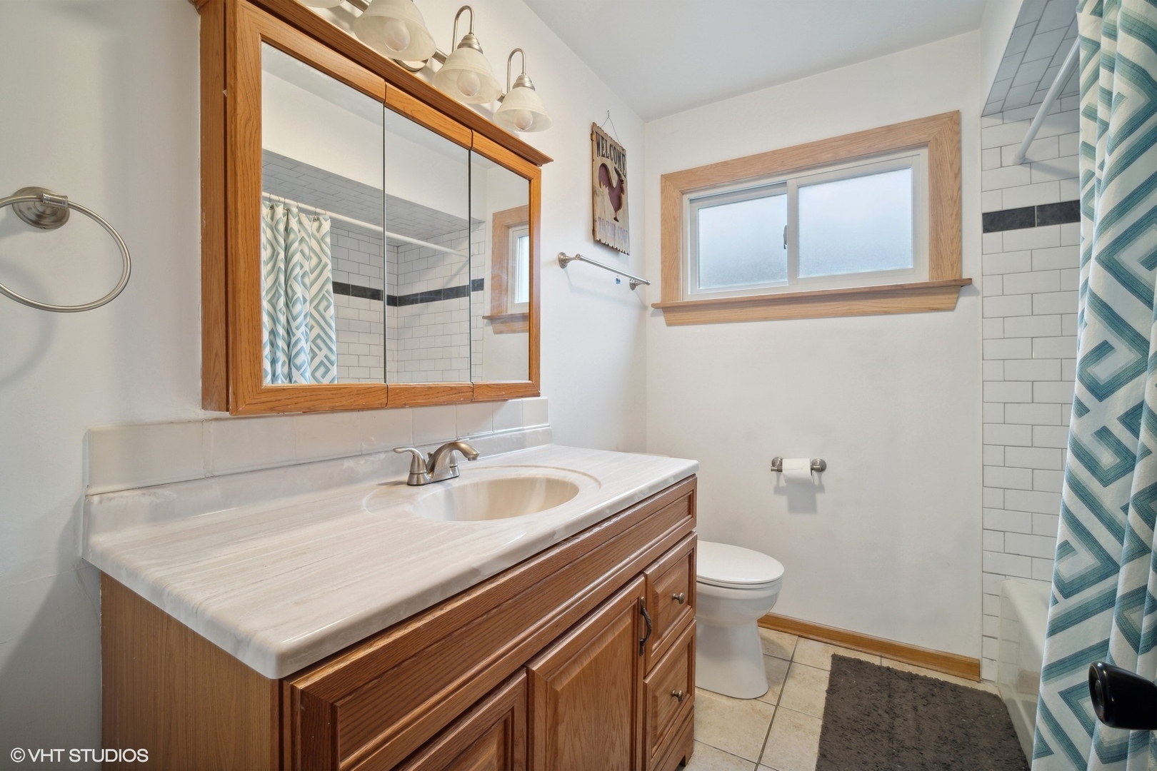 933 North Midlothian Road Mundelein, IL 60060 - Photo 11 of 16 a bathroom with a sink a toilet and a mirror