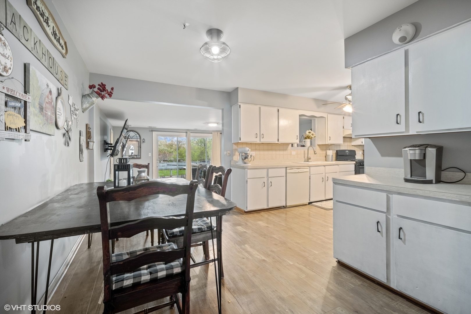 933 North Midlothian Road Mundelein, IL 60060 - Photo 5 of 16 a kitchen with a dining table chairs and white cabinets