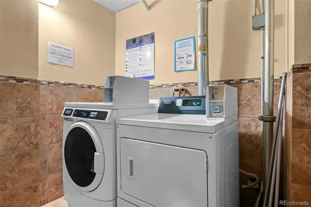 a view of a storage and utility room with washer and dryer