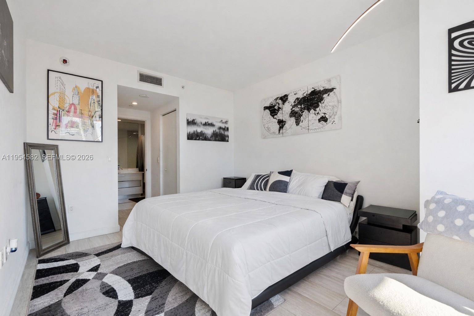 55 Southwest 9th Street, Unit 3005 Miami, FL 33130 - Photo 14 of 23 a bedroom with a bed and a flat screen tv