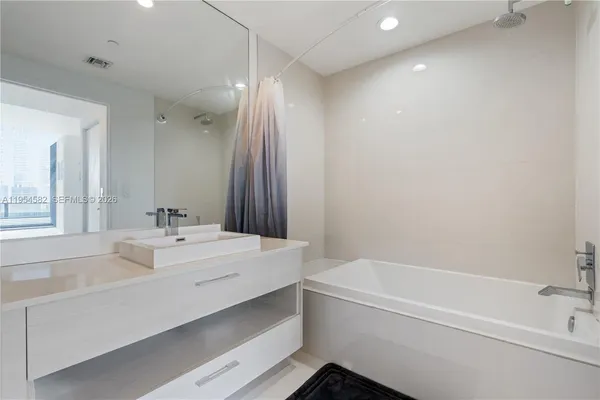 a bathroom with a bathtub and a sink