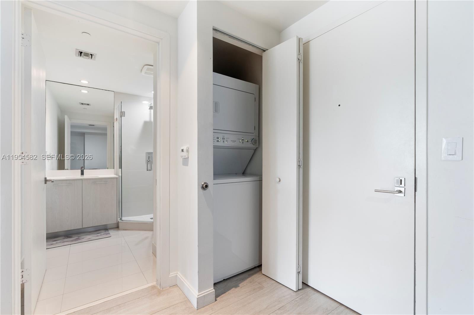 55 Southwest 9th Street, Unit 3005 Miami, FL 33130 - Photo 19 of 23 a view of a bathroom from the hallway with toilet
