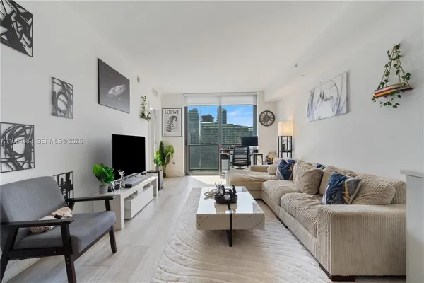 a living room with furniture and a flat screen tv